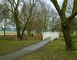 A view to the white posted bridge in riverside park